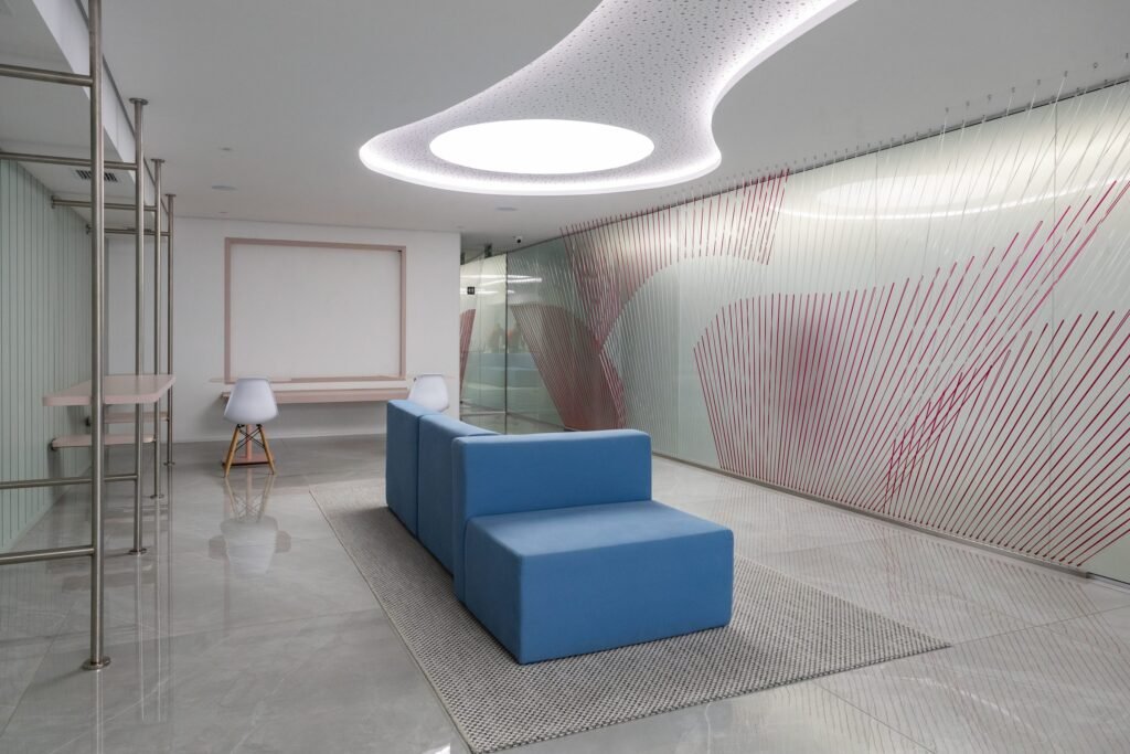 Recepção da Inside Diagnósticos com sofá azul e painel de vidro com grafismo rosa
